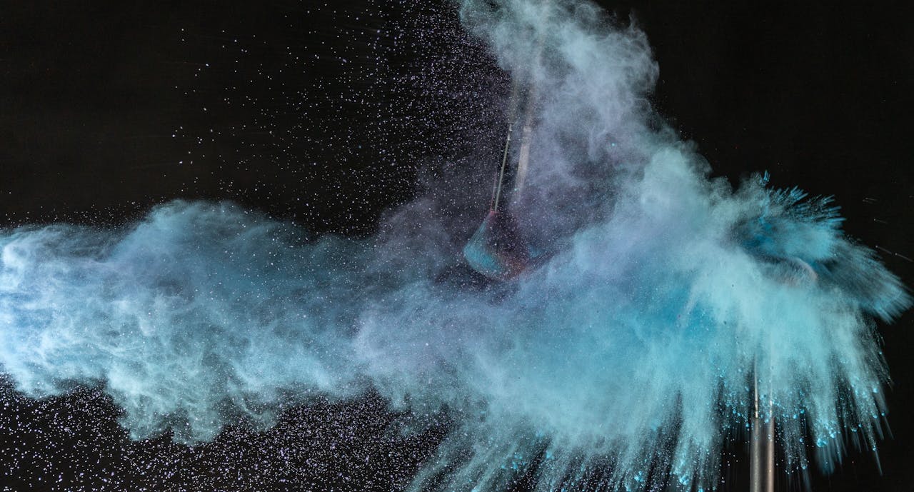 The Art of Drawing Readers In: Your attractive post title goes here Explosive splash of blue powder creating vibrant cloud effect against black background.